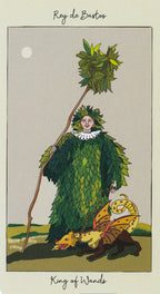 Card from a tarot deck featuring a person in a leafy costume with a staff and a small creature, labeled 'King of Wands'.