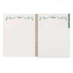 Open spiral-bound gardening planner showing January and February pages with decorative elements.
