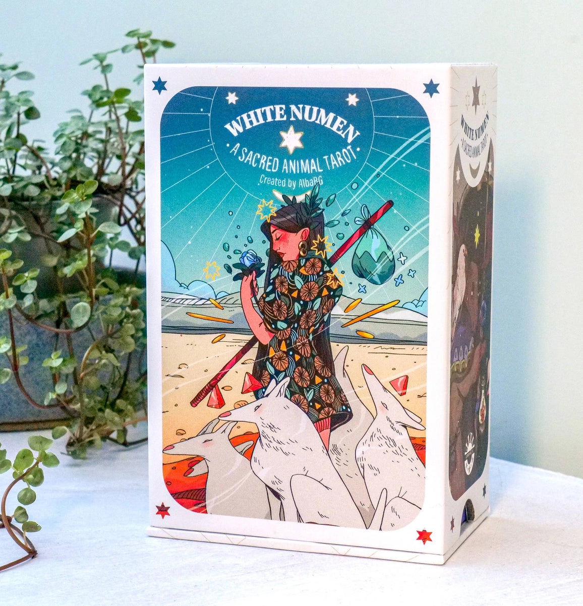 Cardboard box for 'White Numen' tarot cards with colorful design and text.