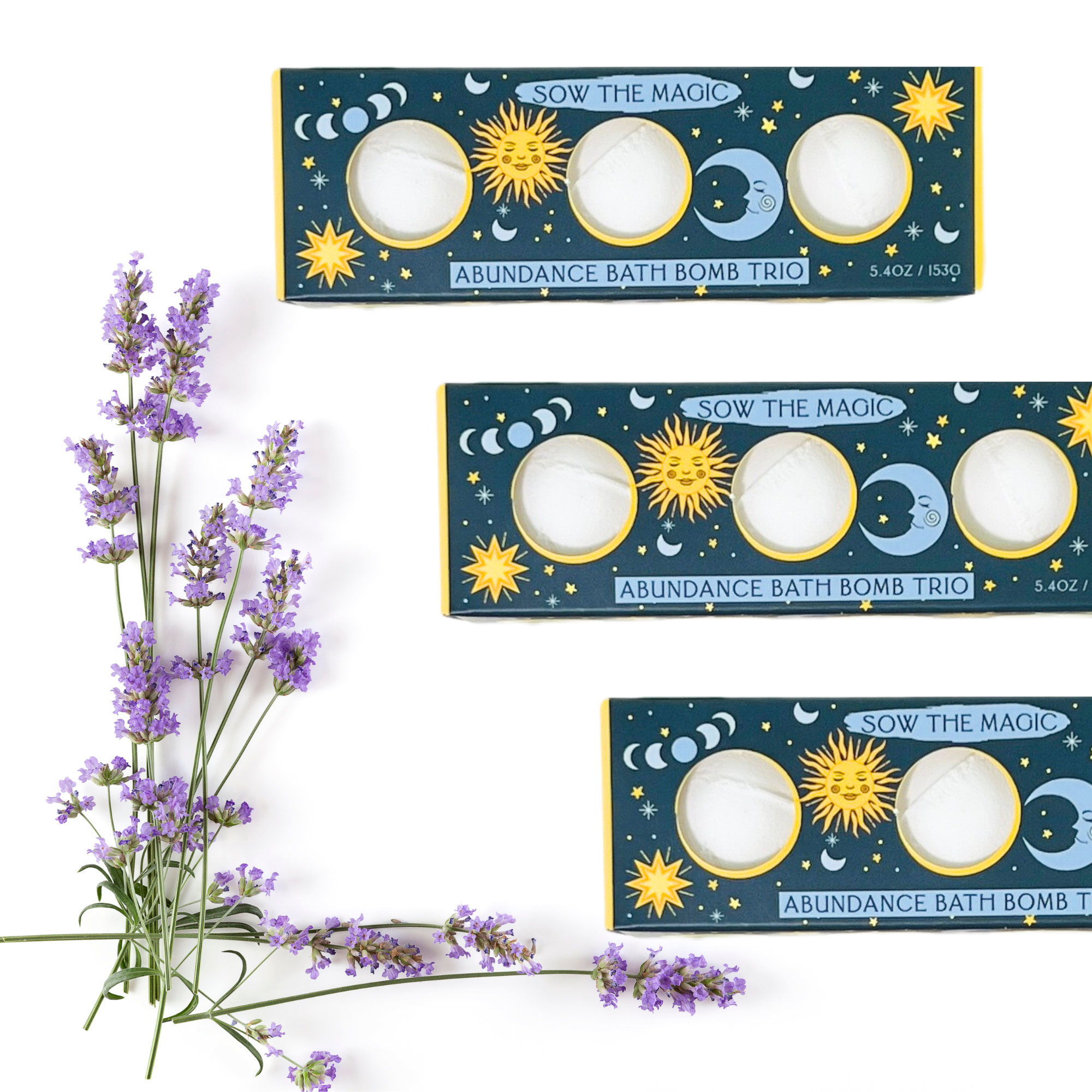 Three boxes of 'Abundance Bath Bomb Trio' with lavender flowers on a white background