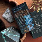 Meraki Tarot cards on a wooden surface with decorative elements