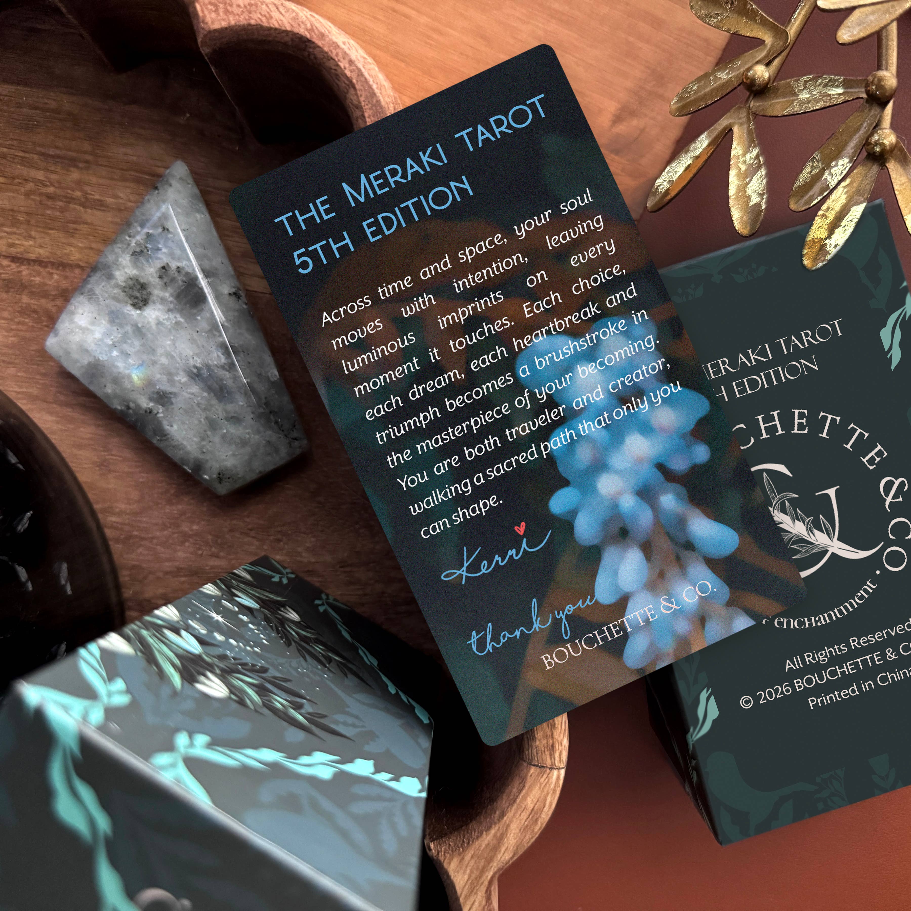 Meraki Tarot cards on a wooden surface with decorative elements