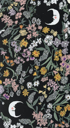 Floral pattern with moon and star designs on a black background