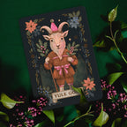Card featuring a goat-like creature in a fantasy setting with floral elements on a dark green background.