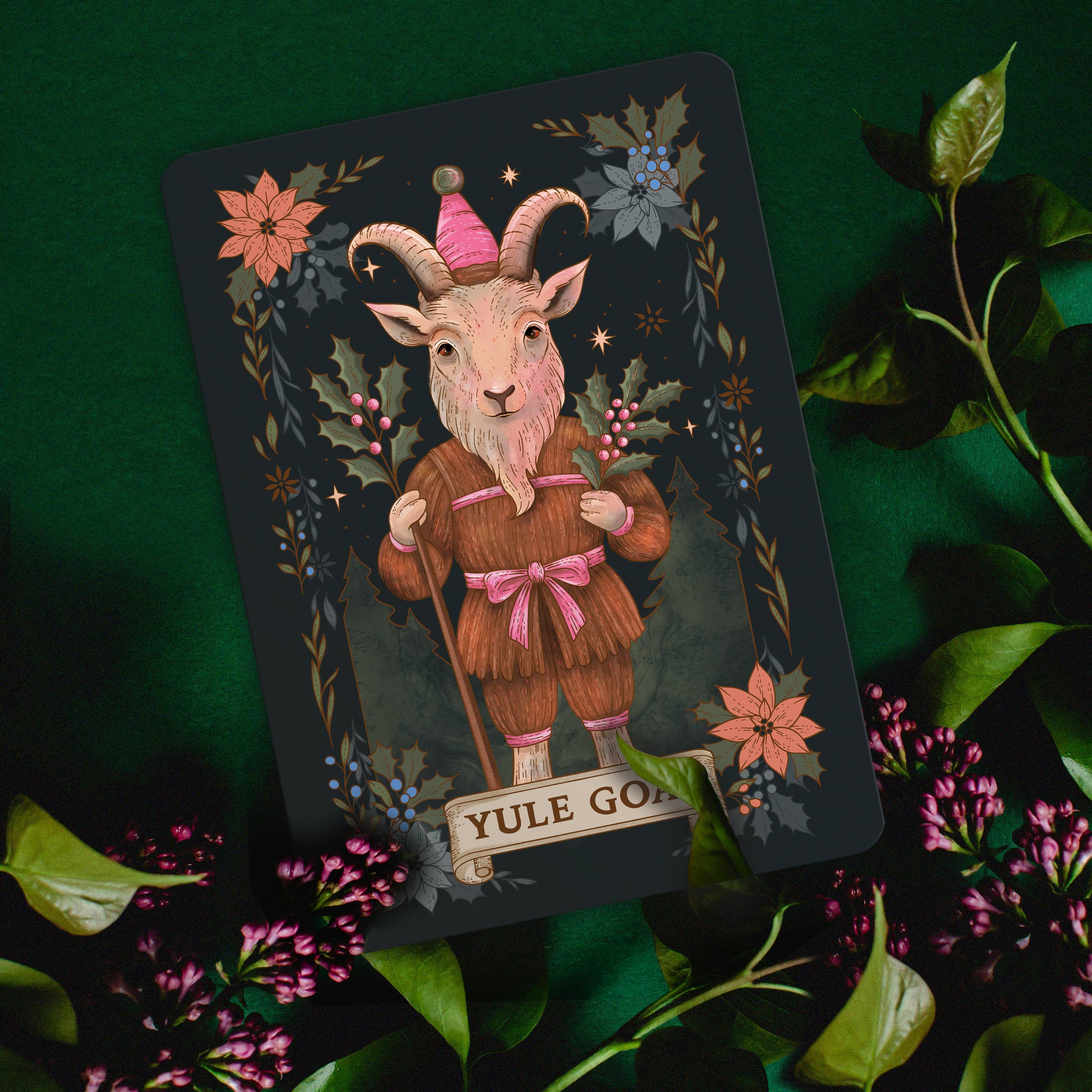 Card featuring a goat-like creature in a fantasy setting with floral elements on a dark green background.