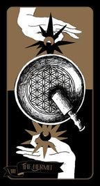 Tarot card featuring hands holding a crystal ball with geometric symbols on a brown and black background.