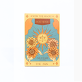 A tarot card style patchouli salt soak packet labeled 'THE SUN' with a central sun face, four sunflowers, and the words 'SOW THE MAGIC' and 'PATCHOULI' on a cream background.