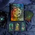 Set of tarot cards with a colorful deck cover on a dark fabric background