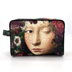 Cosmetic bag with a design of a cracked face and flowers on a white background