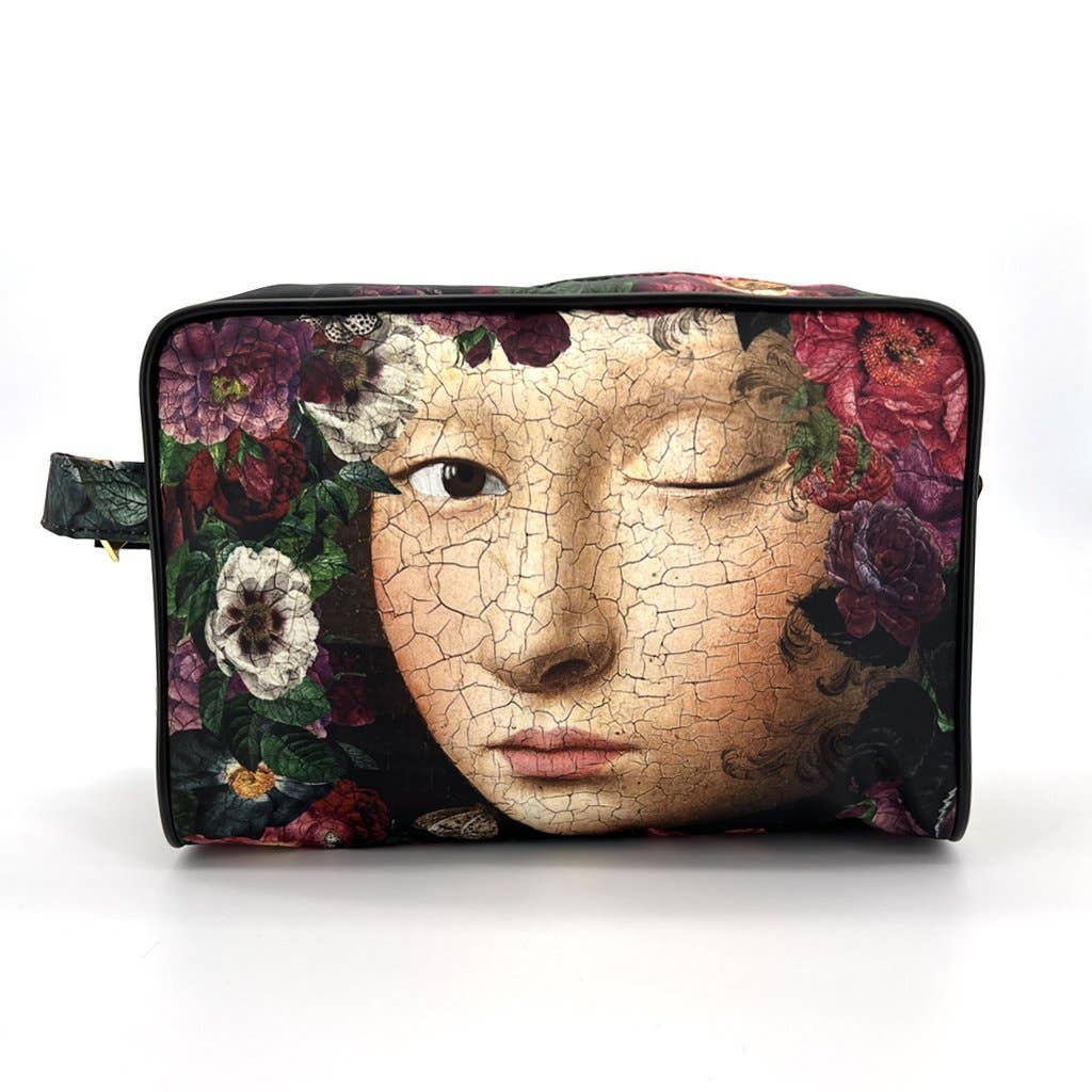 Cosmetic bag with a design of a cracked face and flowers on a white background