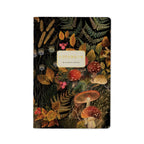 Notebook with a decorative cover featuring mushrooms and foliage on a white background