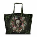 A black tote bag featuring a gothic-style print of a skull surrounded by a colorful floral wreath, with a dark botanical pattern on the sides and handles, shown against a plain white background.