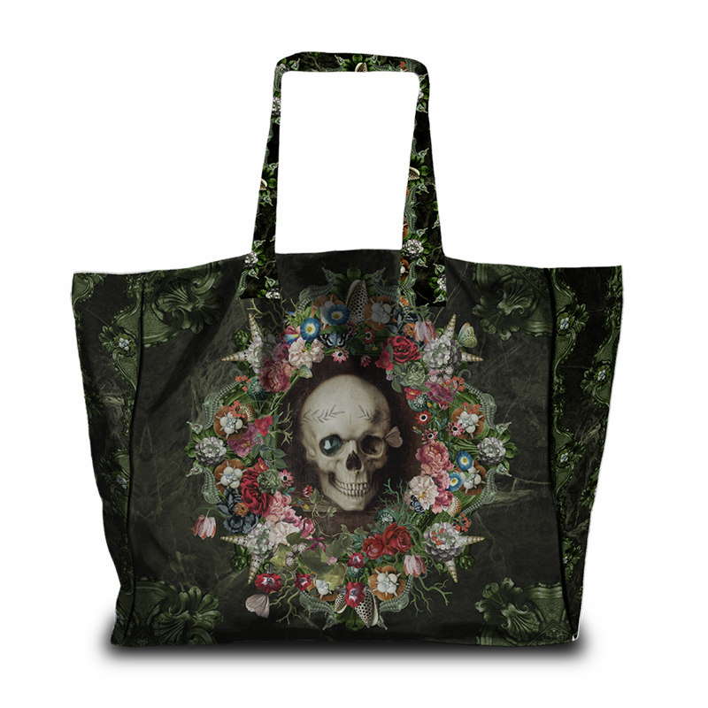 A black tote bag featuring a gothic-style print of a skull surrounded by a colorful floral wreath, with a dark botanical pattern on the sides and handles, shown against a plain white background.