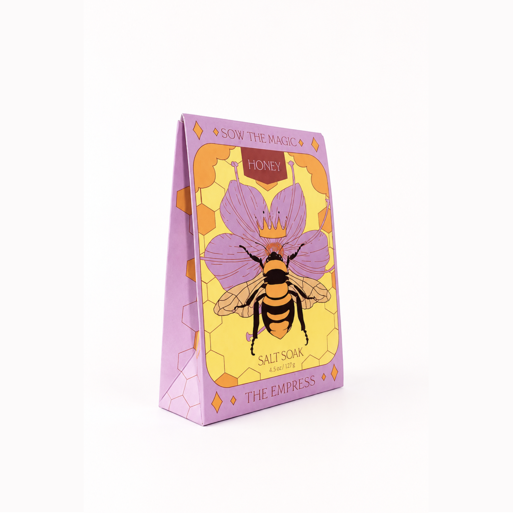 Bloomspell Wild Rose bath bomb in its retail packaging, featuring a pink bath bomb visible through a circular window on a white background.