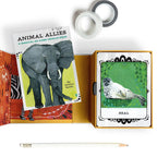 Card deck with elephant illustration and tarot card featuring seal on a white background