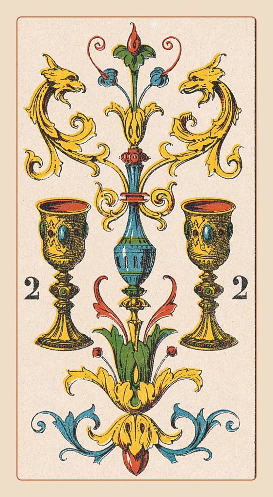 Decorative card with two cups and a central blue element, featuring gold and blue colors.