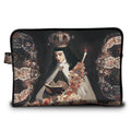 A rectangular zippered pouch featuring a detailed print of a religious painting depicting a nun in a crown and veil holding a book and candle, framed by ornate floral patterns on a black background.