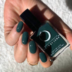 Hand holding a bottle of green nail polish with 'Luna' branding.