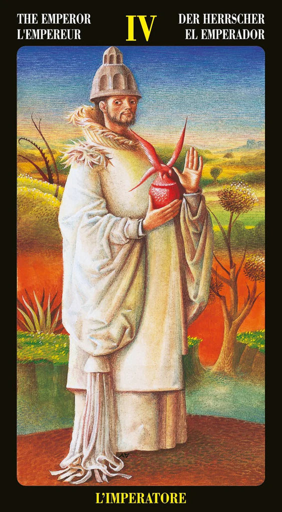 Card from a tarot deck featuring a figure holding a red heart with a desert landscape in the background.