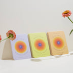 Three books titled 'Back Your Nervous System' with colorful covers on a white surface, accompanied by flowers.