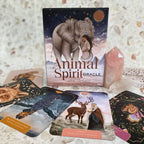 Animal Spirit Oracle card set with cards and crystal on a textured surface