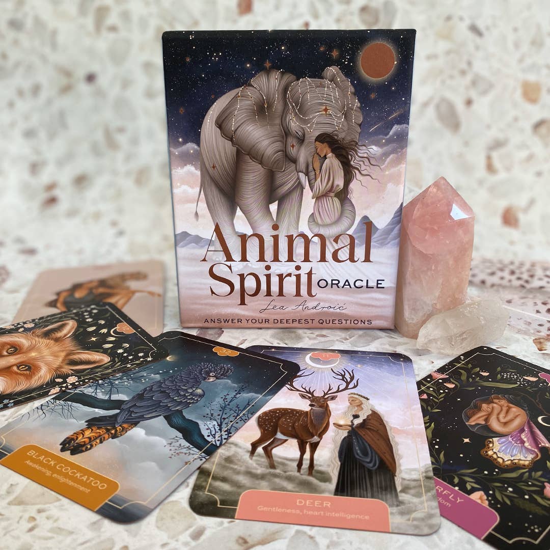 Animal Spirit Oracle card set with cards and crystal on a textured surface