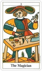 Tarot card featuring 'The Magician' with a person at a table surrounded by various objects.