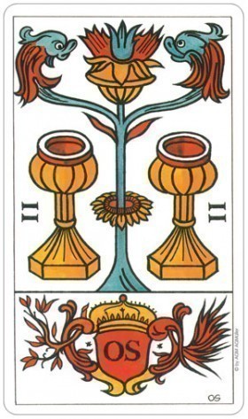 Decorative card with a central floral design and two cups on either side, featuring a coat of arms at the bottom.