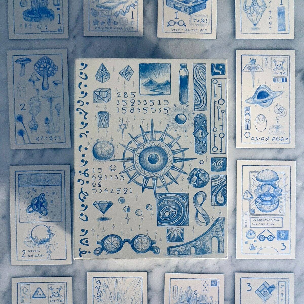 Collection of blue-themed cards with various symbols and designs on a textured surface.