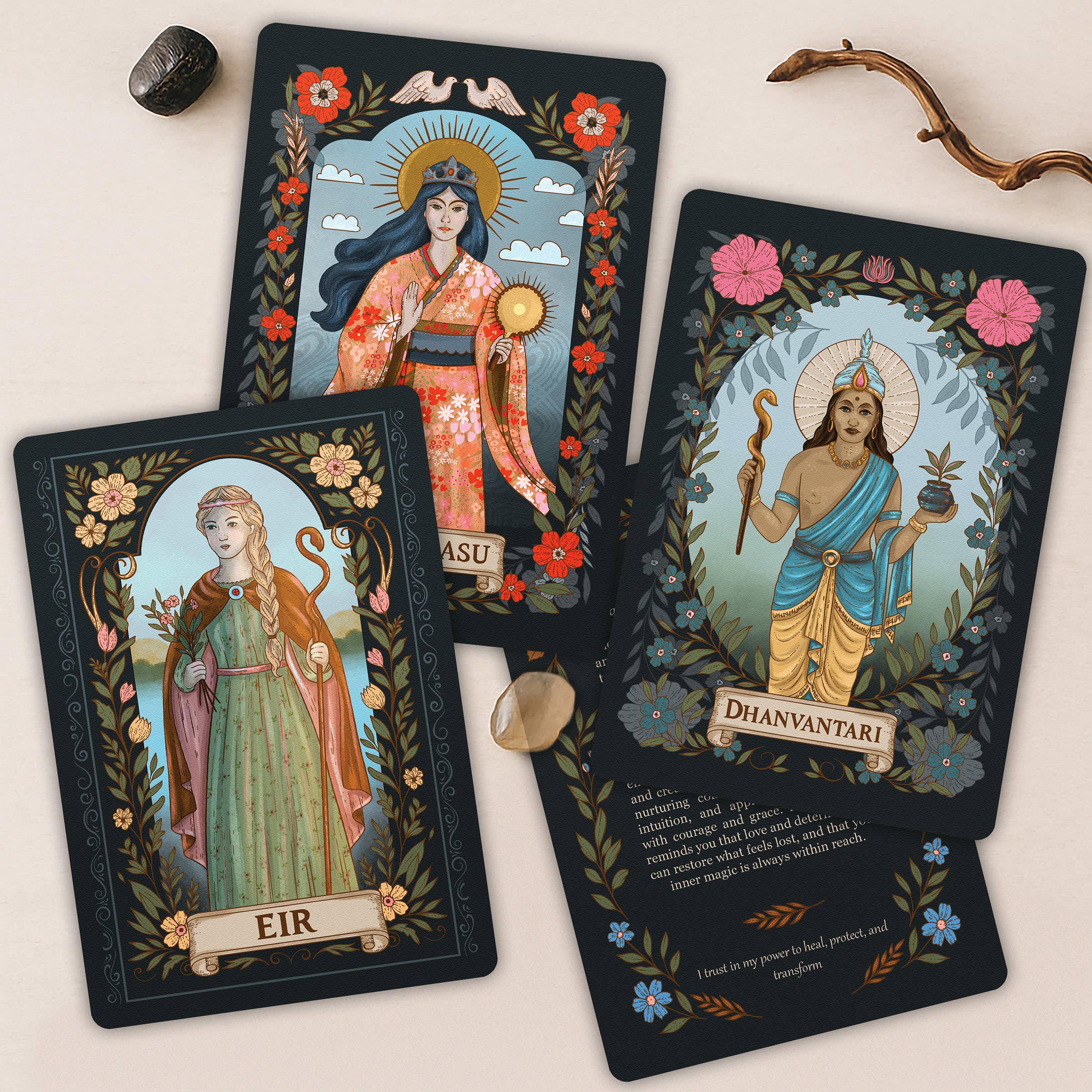 Three tarot cards featuring deities with decorative borders and floral elements on a light background.