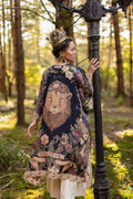 Woman in a patterned dress with lion design standing in a forest.