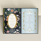 Open book with floral and decorative design on a plain background
