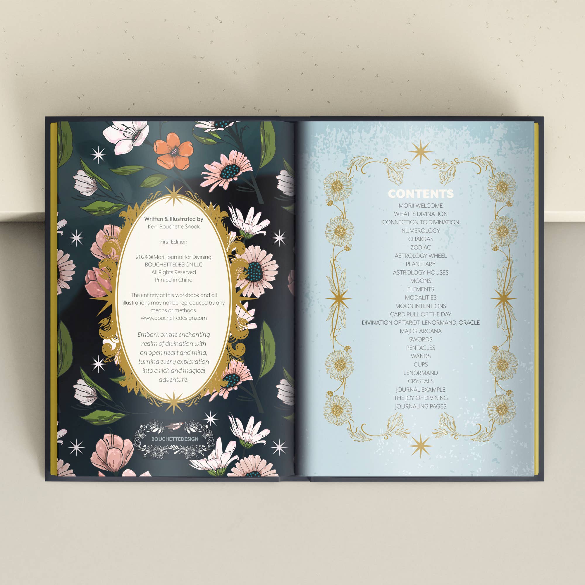 Open book with floral and decorative design on a plain background