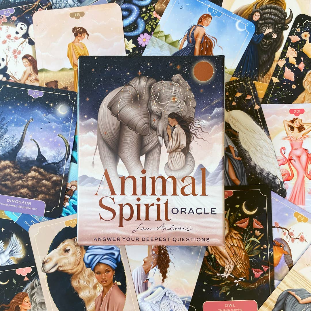 Collection of tarot cards with 'Animal Spirit Oracle' book in the center