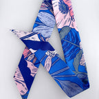 Colorful patterned fabric with blue, pink, and gray design on a white background