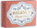 A boxed card game product labeled 'REGENCY Playing Cards' on a plain white background. The box is pink with gold ornamental patterning and a large white central label featuring blue floral vine illustrations and gold lettering.