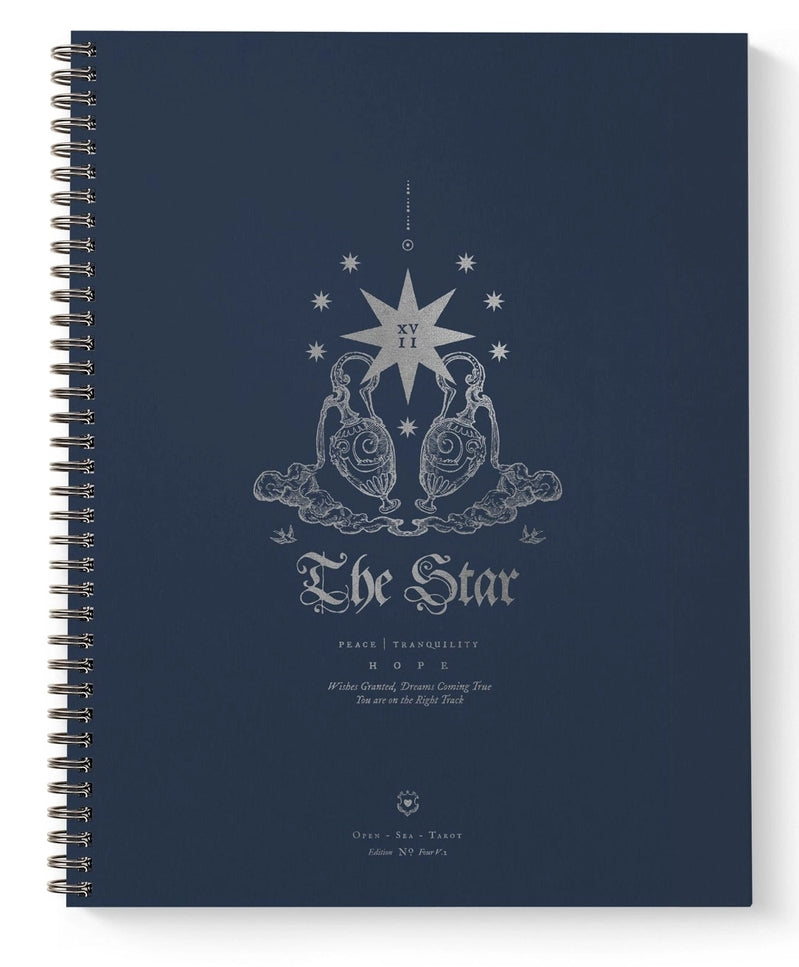 A spiral-bound notebook with a dark navy blue cover featuring a silver-toned celestial illustration and the text 'The Star' on the front, shown against a plain white background.