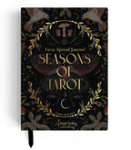 A tarot spread journal titled 'Seasons of Tarot' by Emma Howard, published by Darcel Sorley Publishing. The cover is black with intricate gold and brown illustrations of a stag, birds, a mushroom, a crescent moon, and a central butterfly, accented with gold lettering.