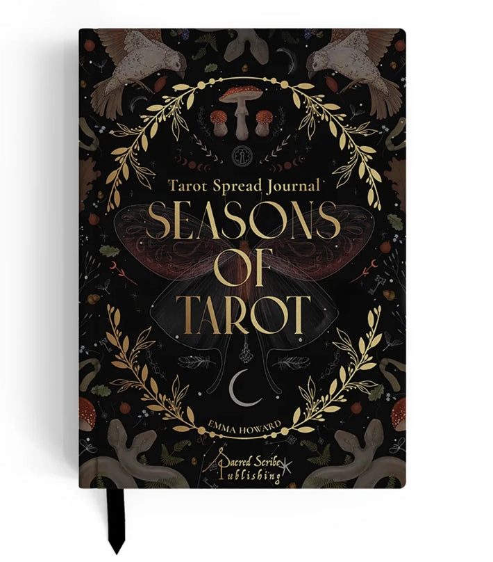 A tarot spread journal titled 'Seasons of Tarot' by Emma Howard, published by Darcel Sorley Publishing. The cover is black with intricate gold and brown illustrations of a stag, birds, a mushroom, a crescent moon, and a central butterfly, accented with gold lettering.