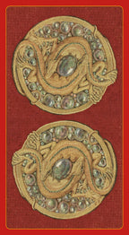Decorative brooches with gemstones on a red background - the back of the Sexual Magic Tarot