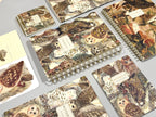 Notebooks with nature-themed covers featuring animals on a gray surface.