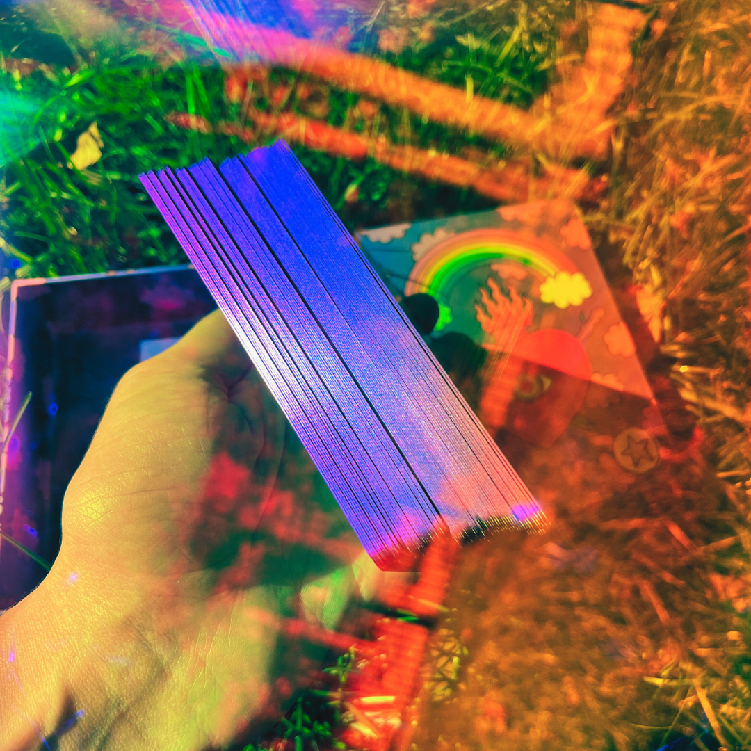 Hand holding a colorful object with a blurred background