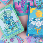 Colorful tarot cards with various designs on a pink background