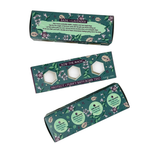 Three boxes of bath bomb trio with herbal design on a white background