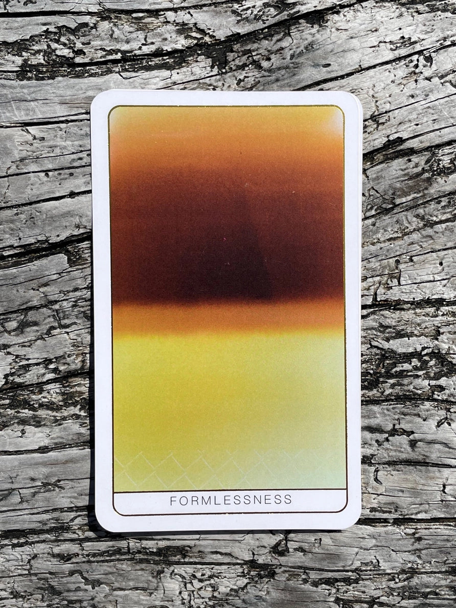 Tarot card titled 'Formlessness' on a wooden surface