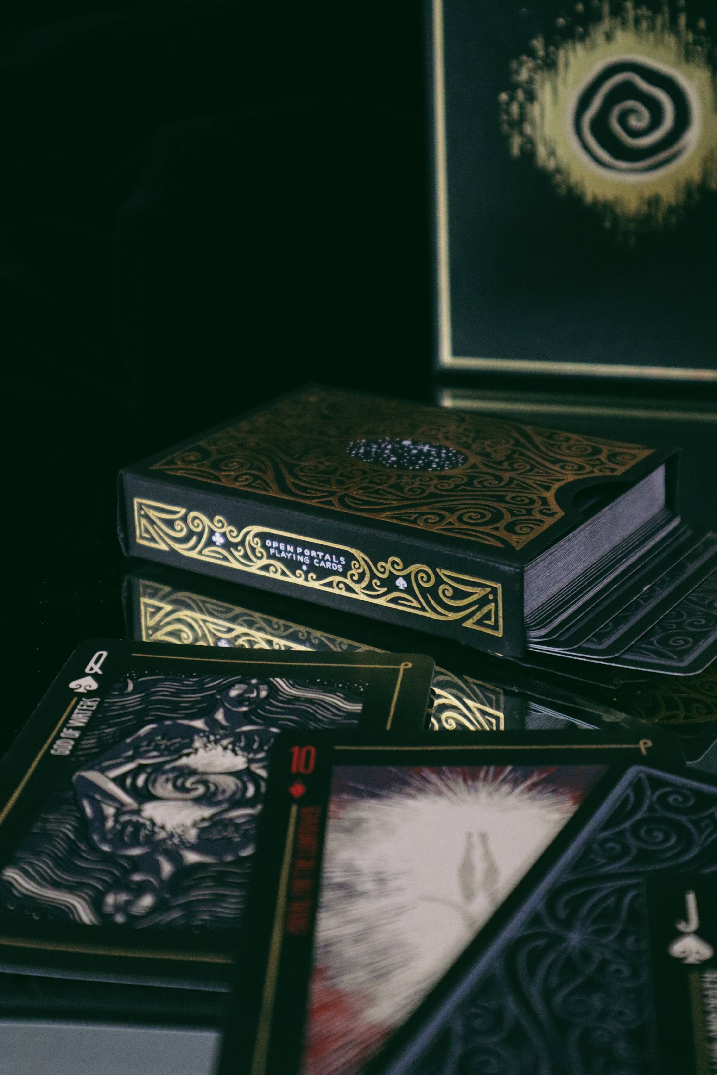 Set of tarot cards with ornate box on a dark surface