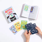 Mystic Cats Tarot cards with a book on a white background