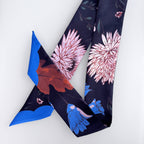 Floral patterned scarf with pink and blue flowers on a white background