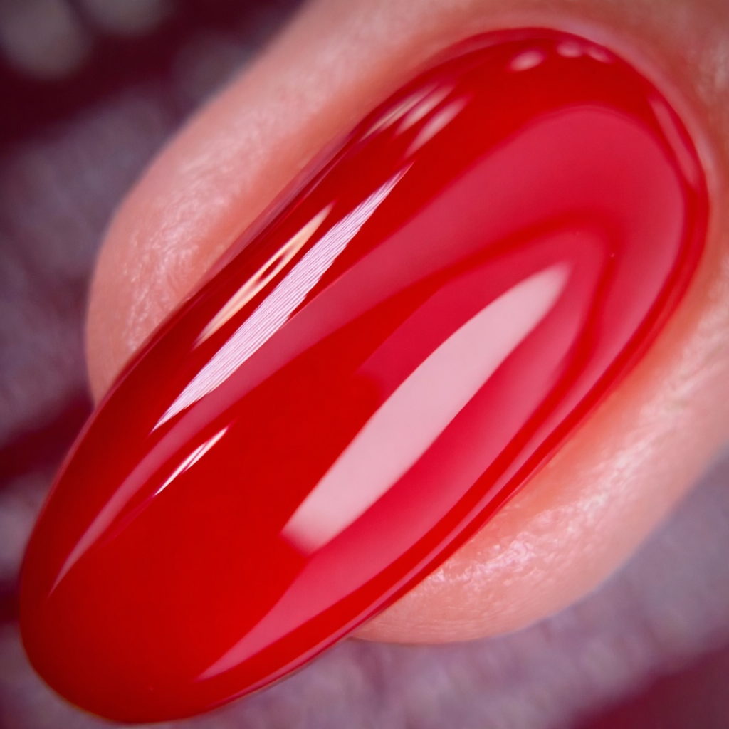 Close-up of a red nail with a glossy finish