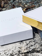 Two books on a wooden surface with a natural background